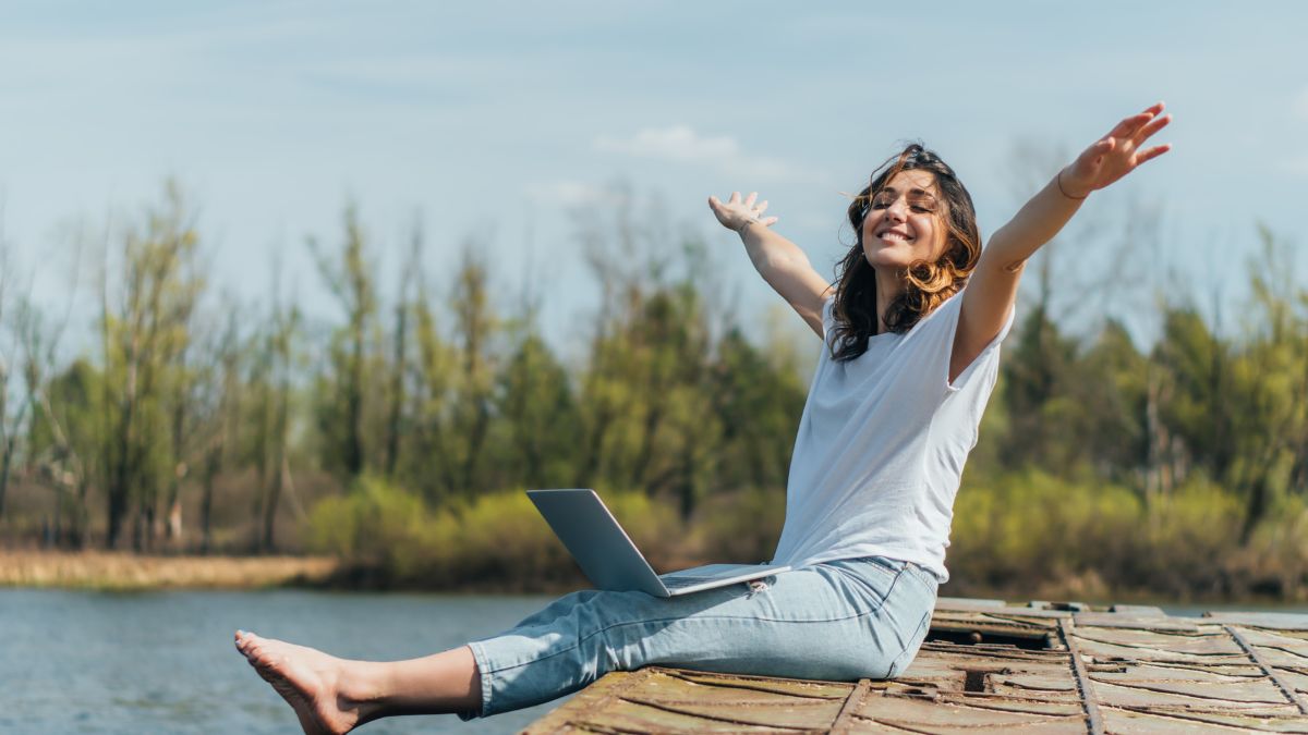 woman happy with computer outside